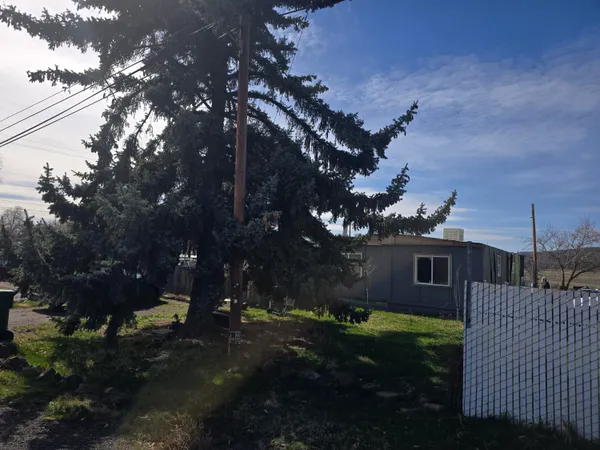 a view of house with yard and green space