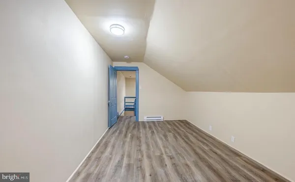 a view of room with stairs and wooden floor