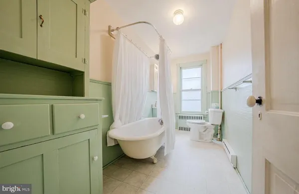 a spacious bathroom with a bathtub sink and toilet