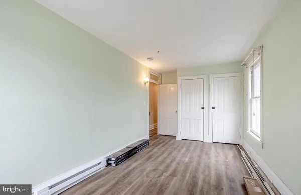 a view of a room with wooden floor