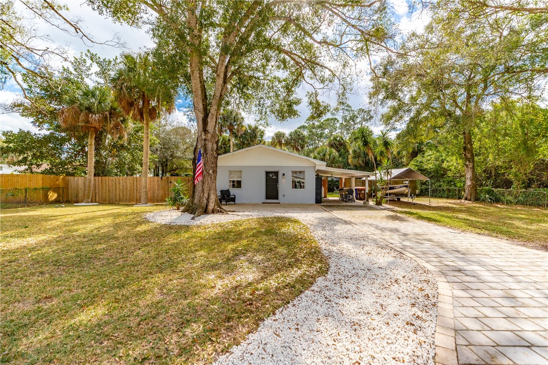 3655 2nd Place Vero Beach, FL 32968 - Photo 1 of 27 a front view of house with yard and trees