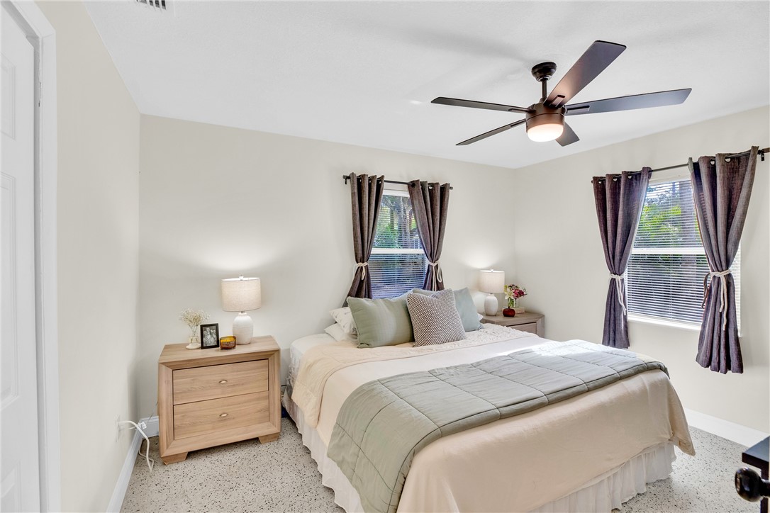 3655 2nd Place Vero Beach, FL 32968 - Photo 12 of 27 a bedroom with a bed and a large mirror