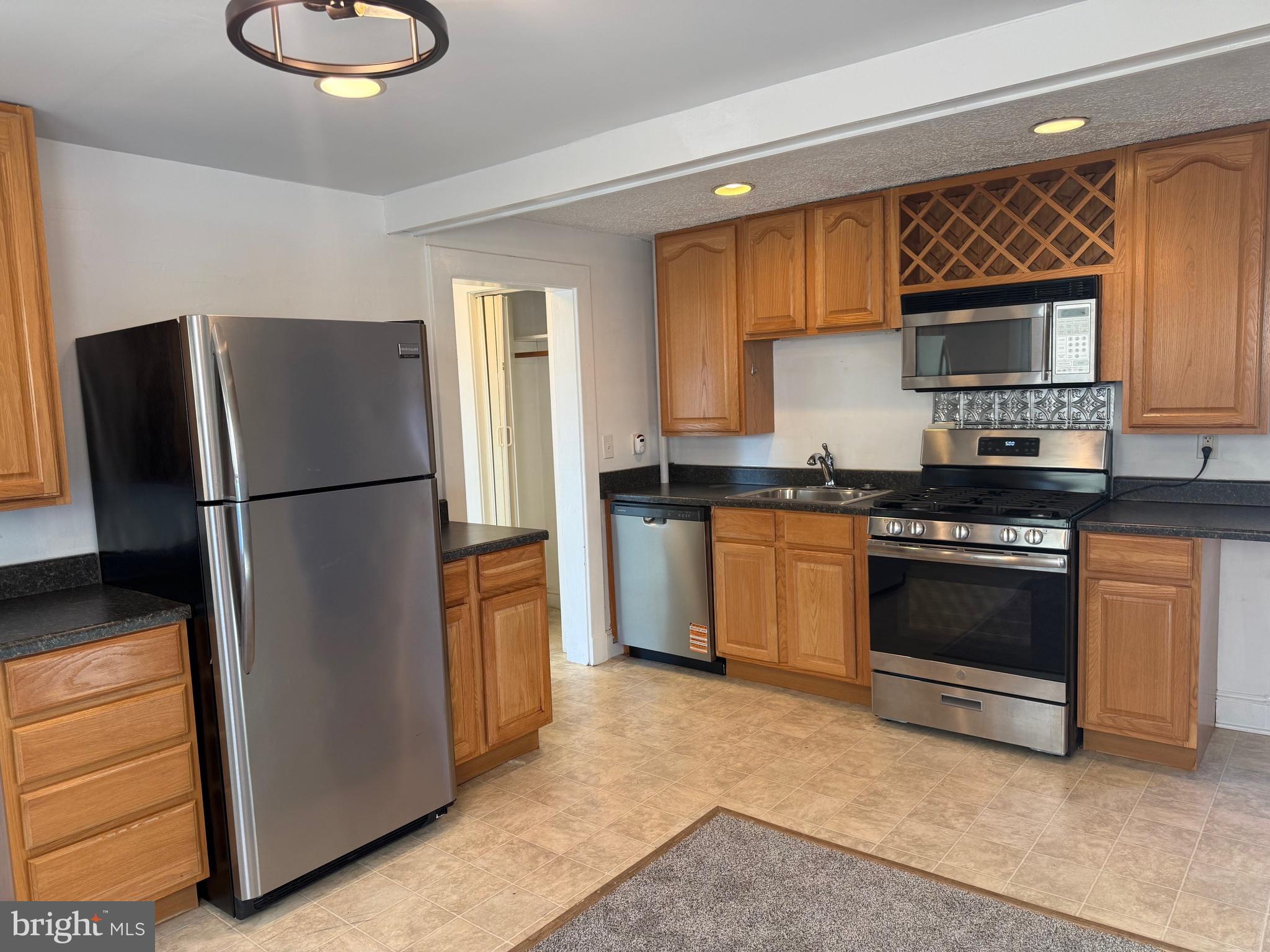 15 Brewer Avenue, Unit B Annapolis, MD 21401 - Photo 8 of 26 a kitchen with stainless steel appliances granite countertop a refrigerator sink stove and cabinets