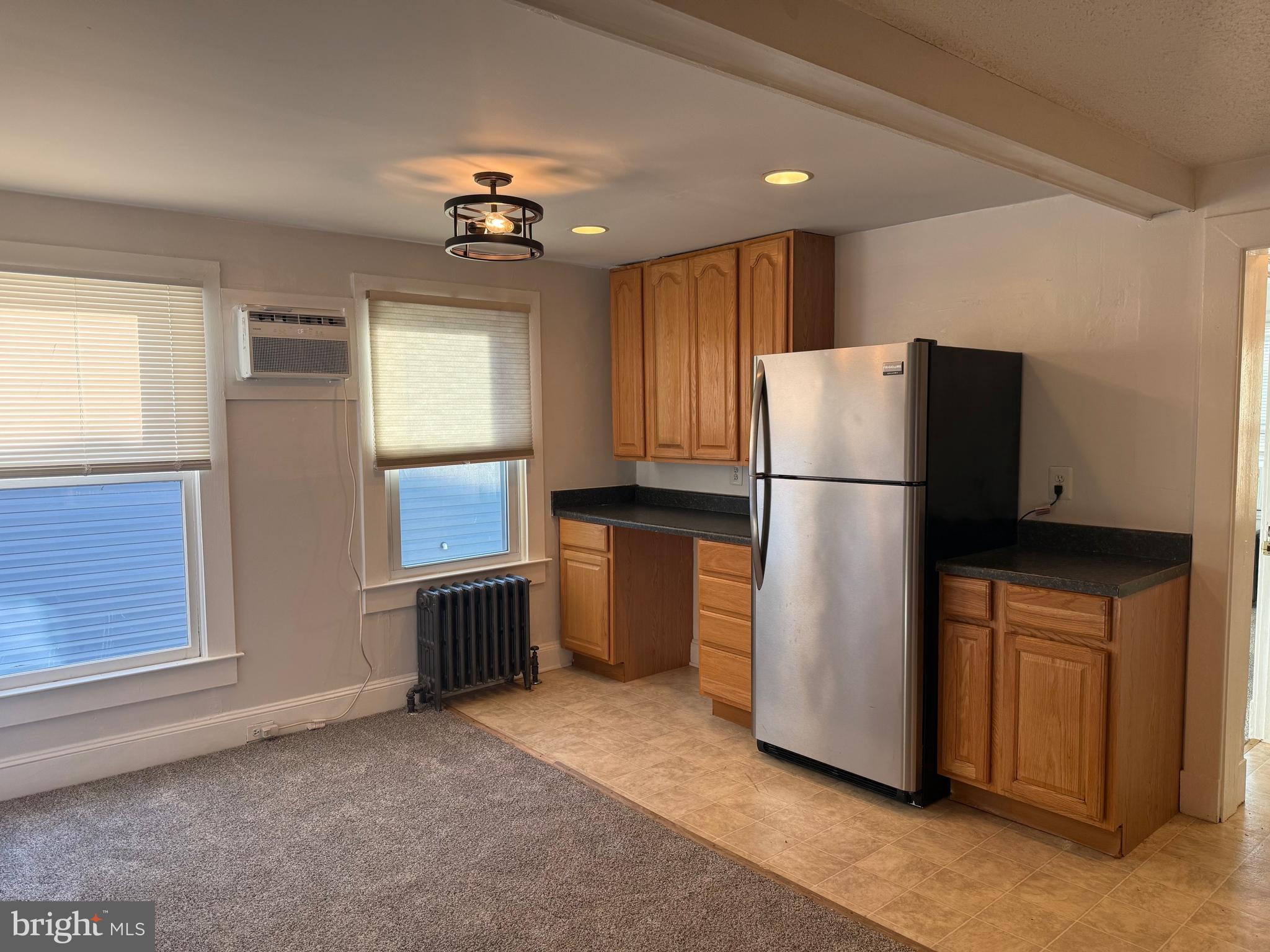 15 Brewer Avenue, Unit B Annapolis, MD 21401 - Photo 9 of 26 a kitchen with refrigerator a washer and dryer