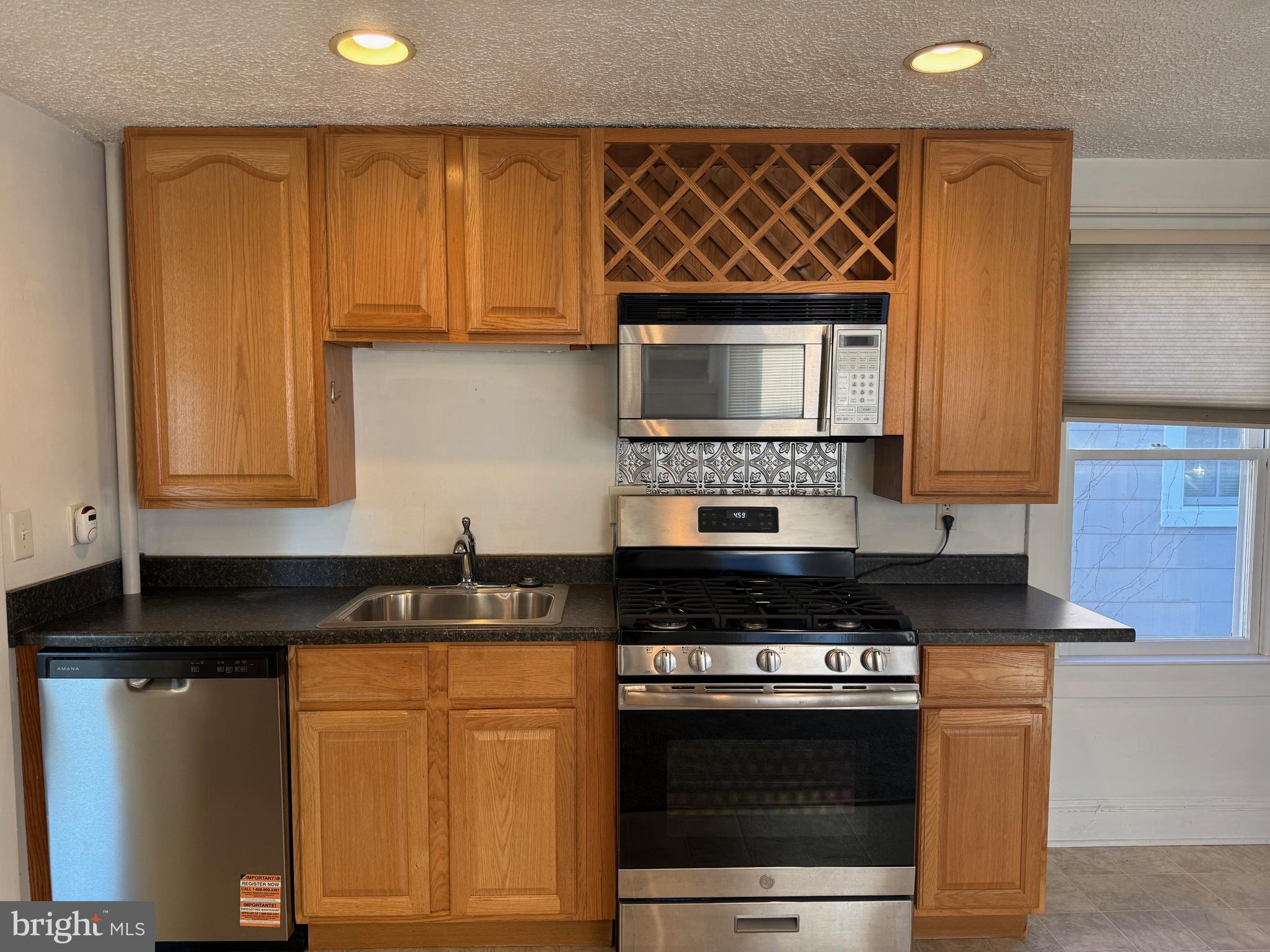 15 Brewer Avenue, Unit B Annapolis, MD 21401 - Photo 10 of 26 a kitchen with stainless steel appliances granite countertop a stove a sink and a microwave