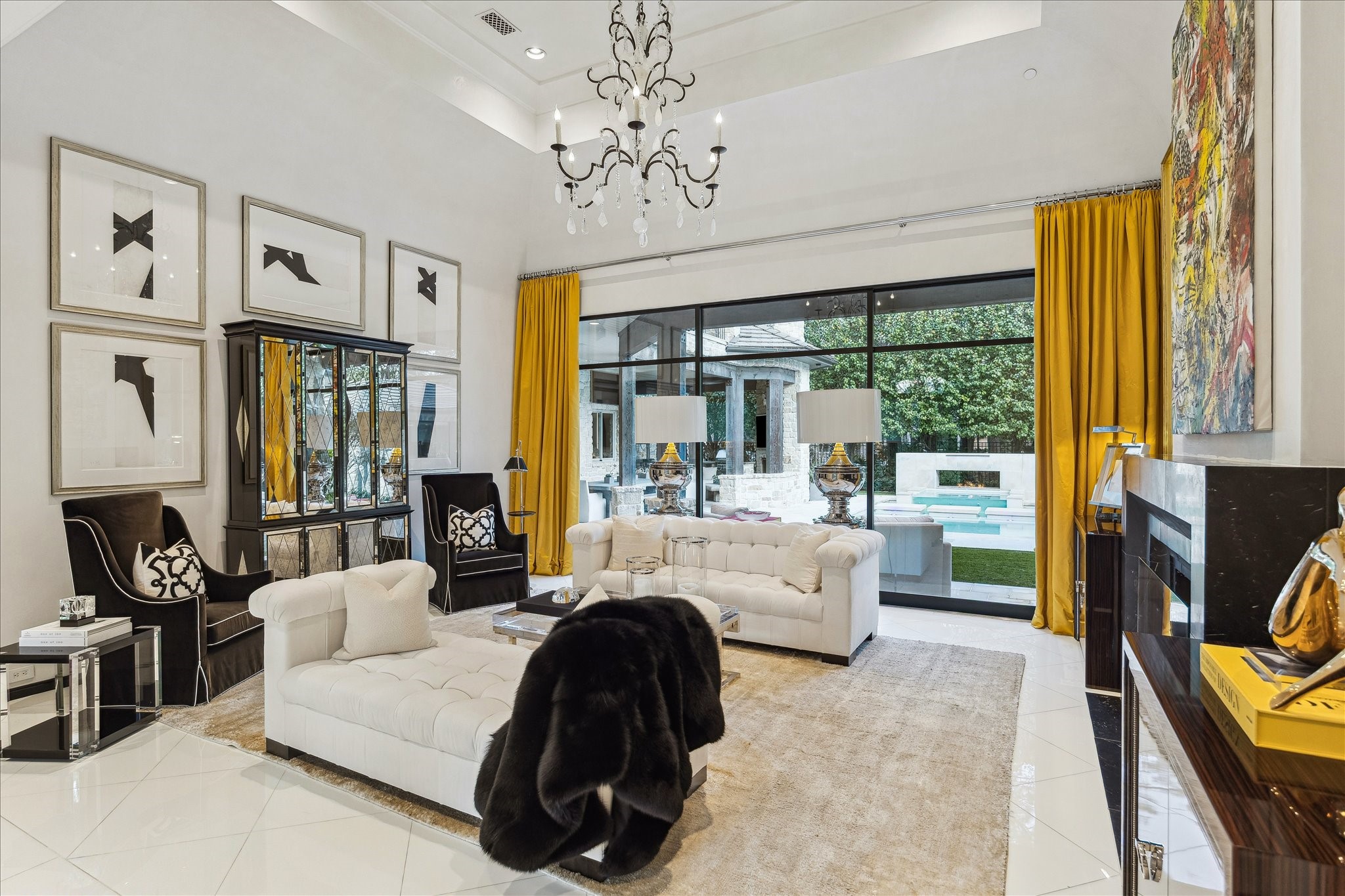 220 Merrie Way Lane Houston, TX 77024 - Photo 7 of 50 Segreto-plastered walls and herringbone Wenge floors lend quiet elegance to this living space. A honed marble fireplace wall and expansive picture windows draw the eye to the peaceful pool and gardens beyond.