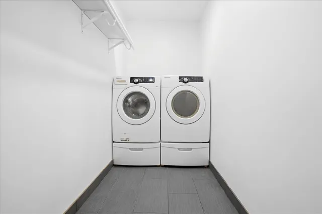 a view of a storage & utility room with dryer and washer