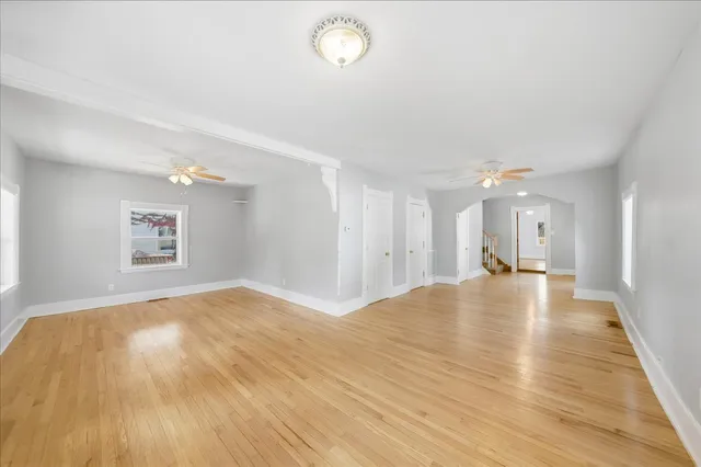 a view of empty room with wooden floor