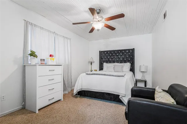 a bedroom with a bed and a couch