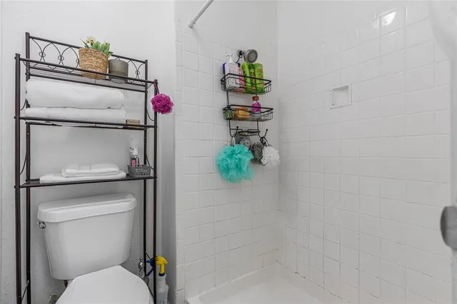 a bathroom with a toilet and a shower