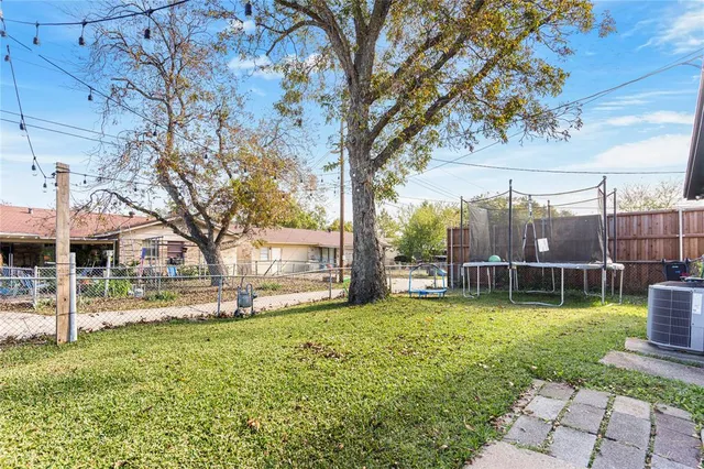 a view of a house with a yard and sitting area