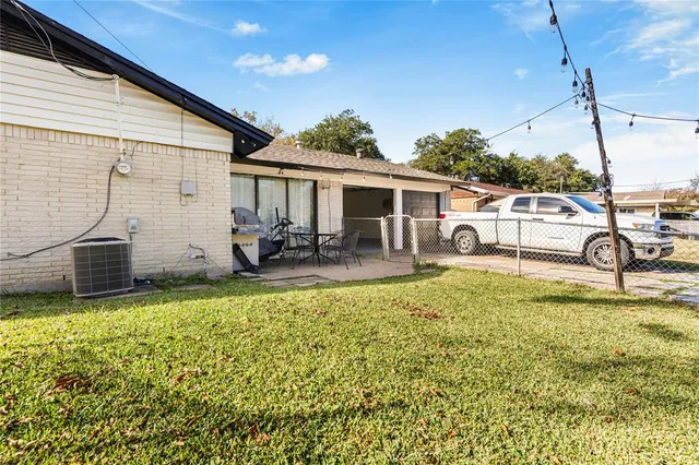 a view of a patio with table and chairs a barbeque with wooden fence