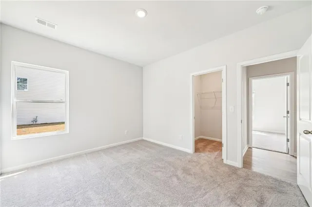 an empty room with windows and closet