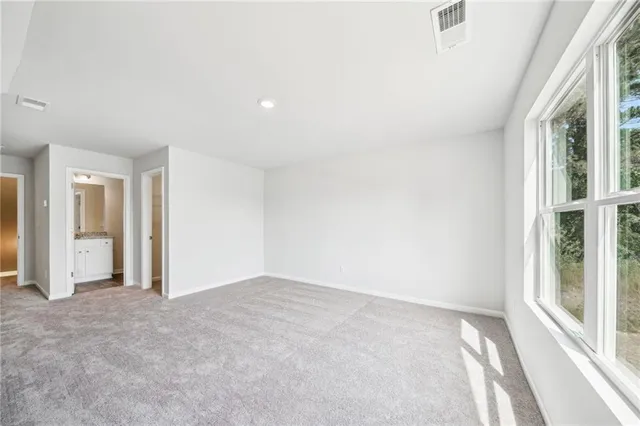 a spacious bathroom with a granite countertop sink mirror and shower