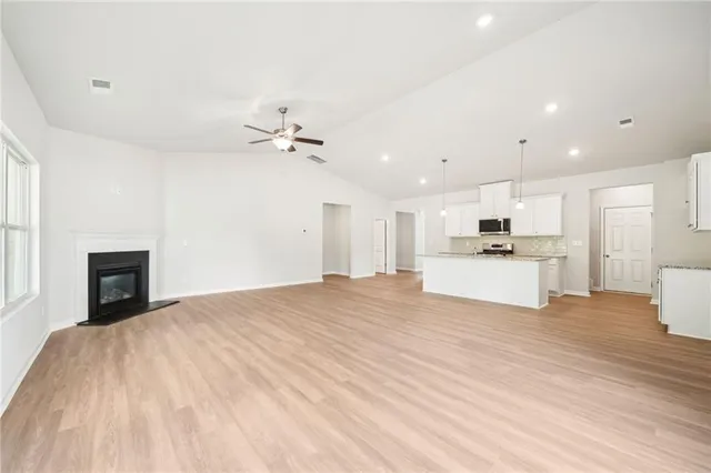 an open kitchen with kitchen island and stainless steel appliances