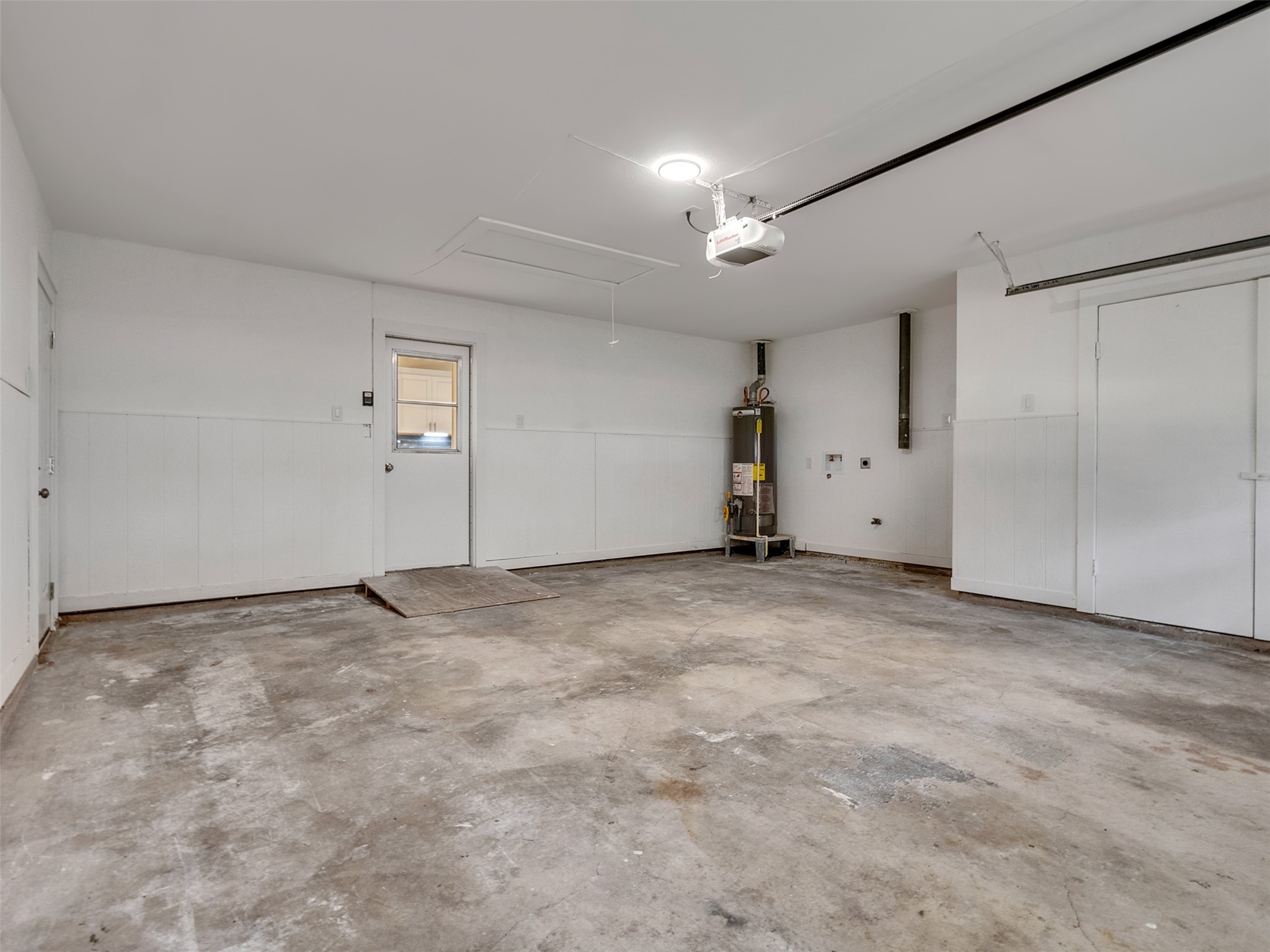 10315 Winding Trail Road La Porte, TX 77571 - Photo 19 of 24 This spacious garage offers ample room for storage or projects, featuring clean white walls for ultimate convenience.