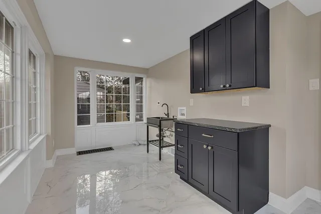 a living room with a large window and furniture