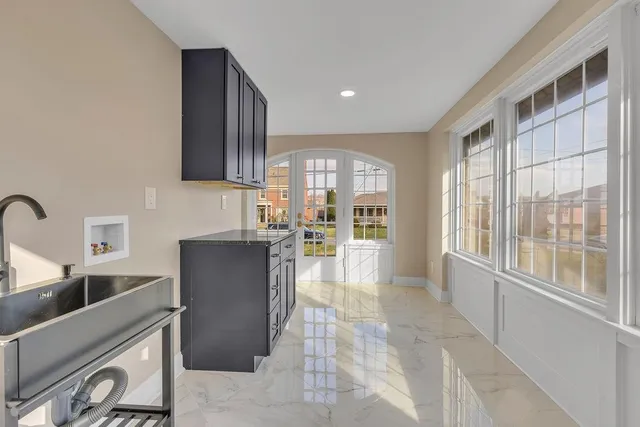 a view of a kitchen with a sink and cabinets