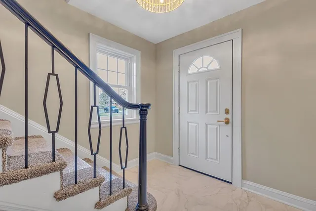 a view of an entryway with wooden floor