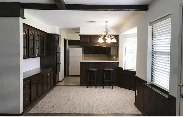 a kitchen with refrigerator and cabinets