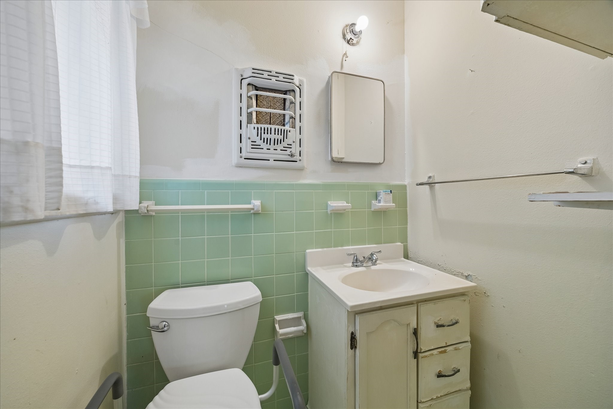 6131 Birdwood Road Houston, TX 77074 - Photo 12 of 14 a bathroom with a toilet sink and mirror