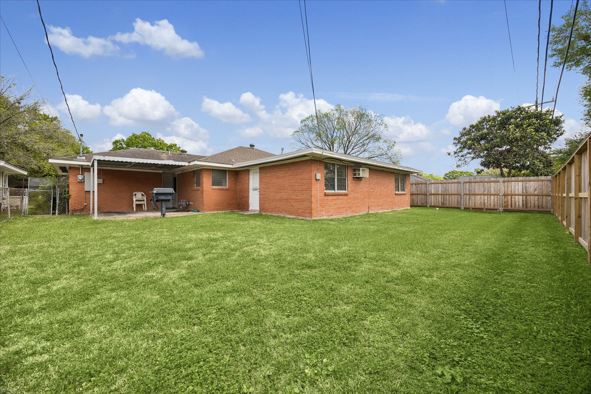 6131 Birdwood Road Houston, TX 77074 - Photo 13 of 14 a front view of house with yard and trees in the background
