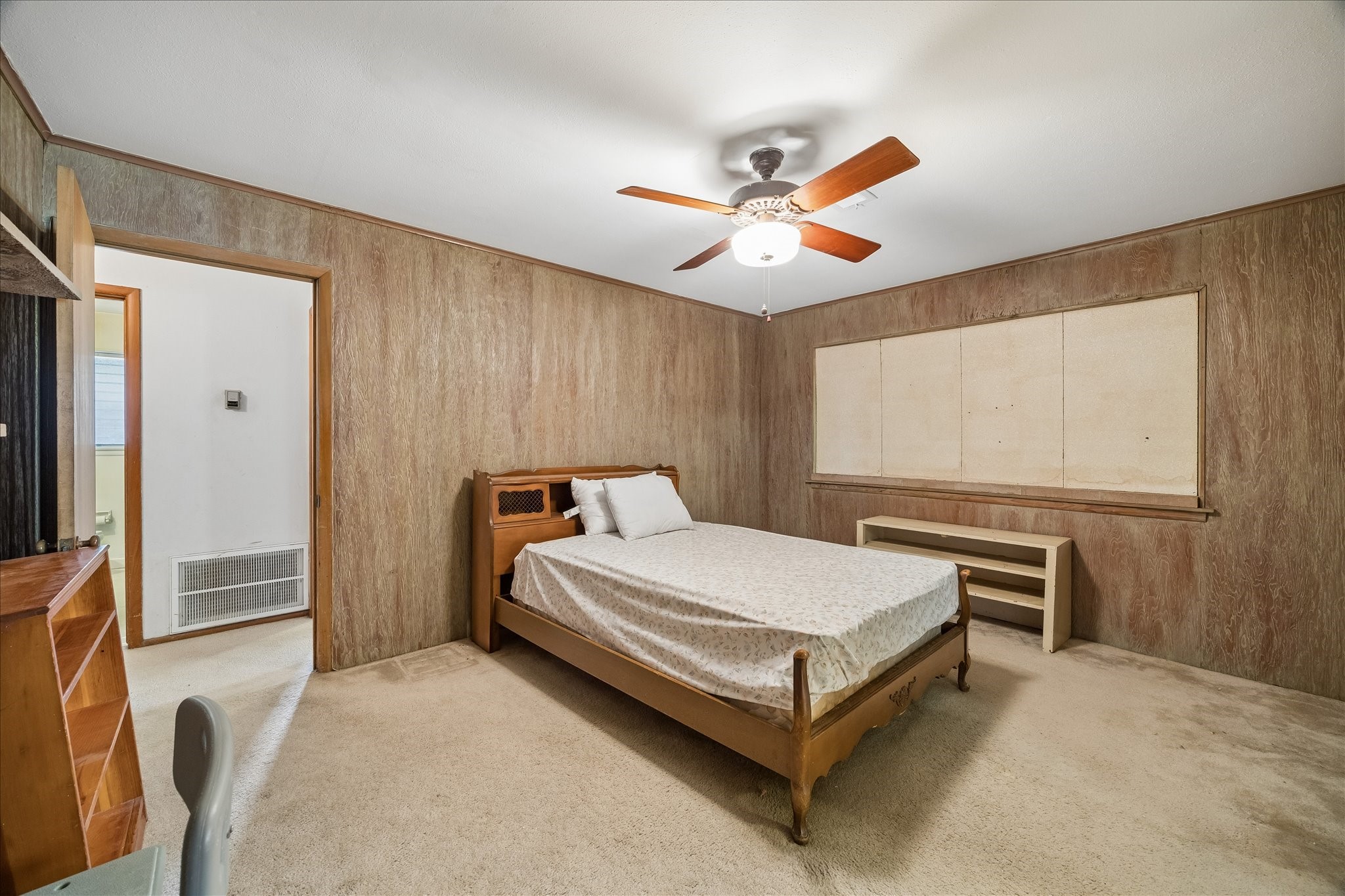 6131 Birdwood Road Houston, TX 77074 - Photo 6 of 14 a bedroom with a bed and a chandelier