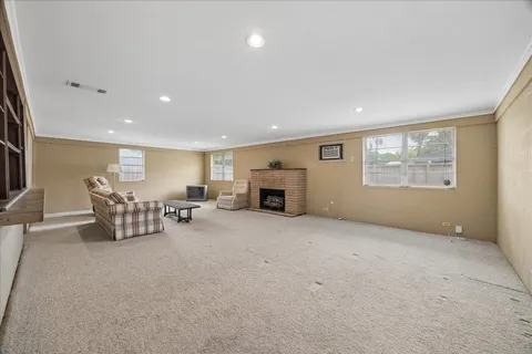 a big room with furniture a fireplace and window