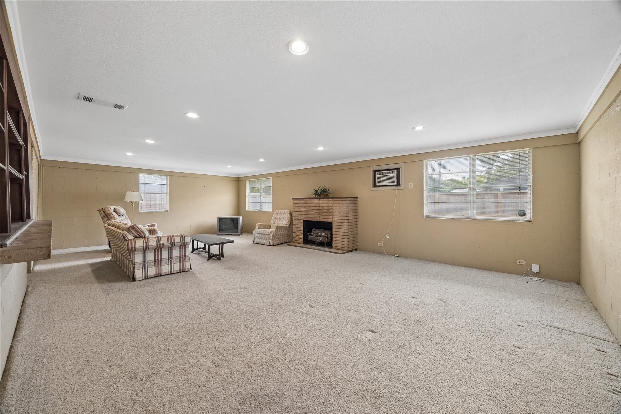 6131 Birdwood Road Houston, TX 77074 - Photo 7 of 14 a big room with furniture a fireplace and window