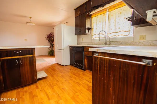 a kitchen with a sink and a wooden cabinets