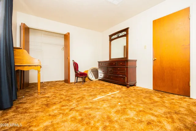 a view of an empty room with a fireplace and a window