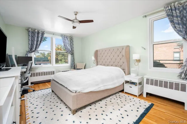 a bedroom with a bed a window and a chandelier