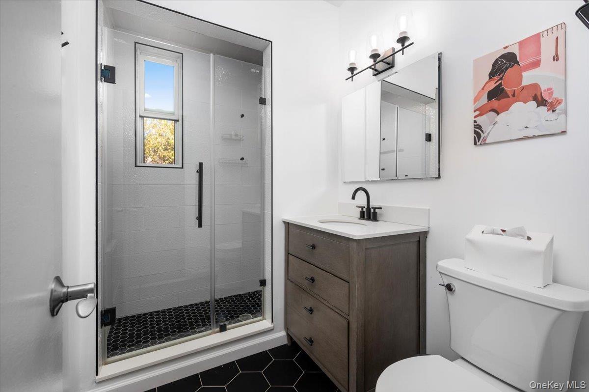 953 West Boston Post Road, Unit 3G Mamaroneck, NY 10543 - Photo 15 of 23 a bathroom with a sink a toilet and shower