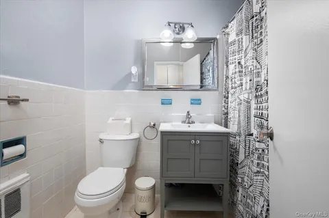 a bathroom with a sink a toilet and shower curtain