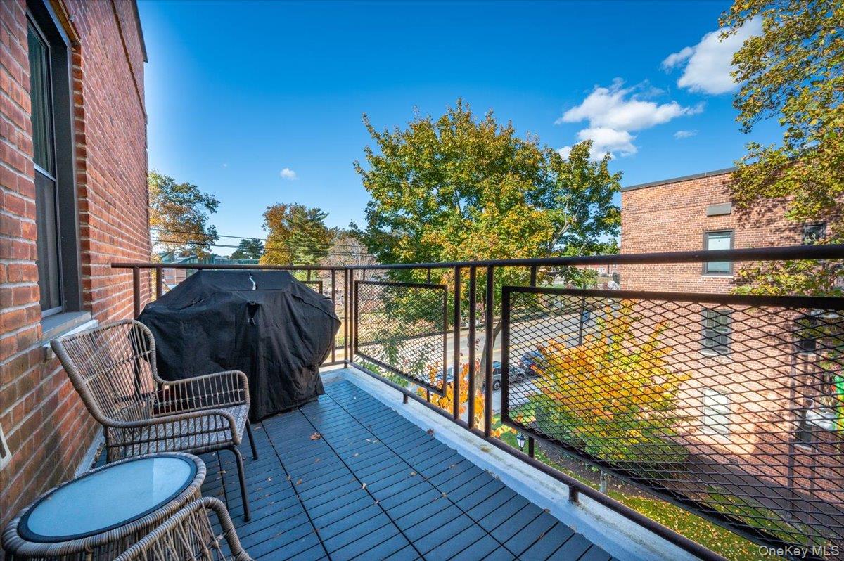 953 West Boston Post Road, Unit 3G Mamaroneck, NY 10543 - Photo 18 of 23 a balcony with wooden floor and outdoor seating