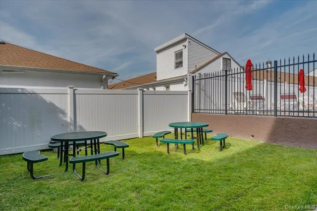 a backyard of a house with table and chairs