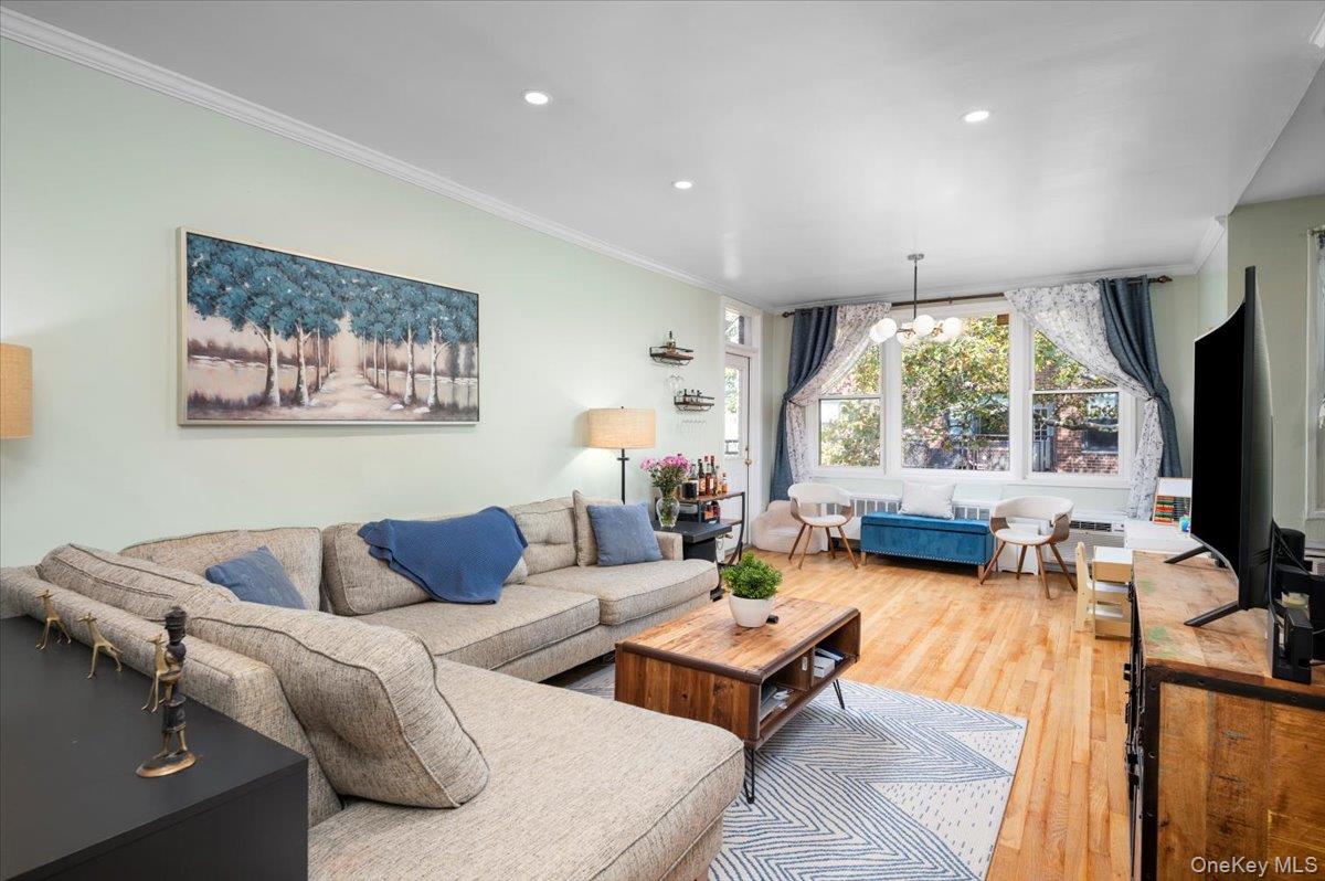953 West Boston Post Road, Unit 3G Mamaroneck, NY 10543 - Photo 8 of 23 a living room with furniture a large window and a flat screen tv