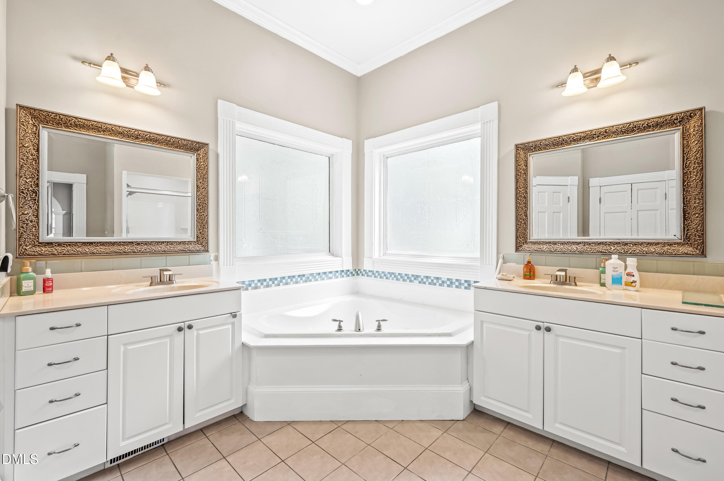 1957 Hilltop Road Raleigh, NC 27610 - Photo 18 of 46 a bathroom with a bathtub a sink and a window