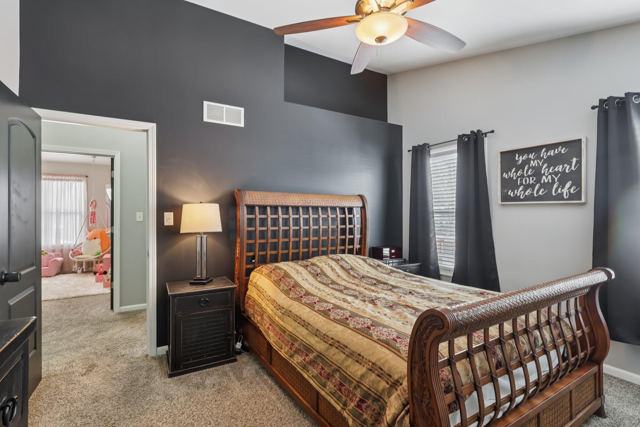 2235 Coldspring Road Crown Point, IN 46307 - Photo 29 of 51 a bedroom with a bed and a chandelier