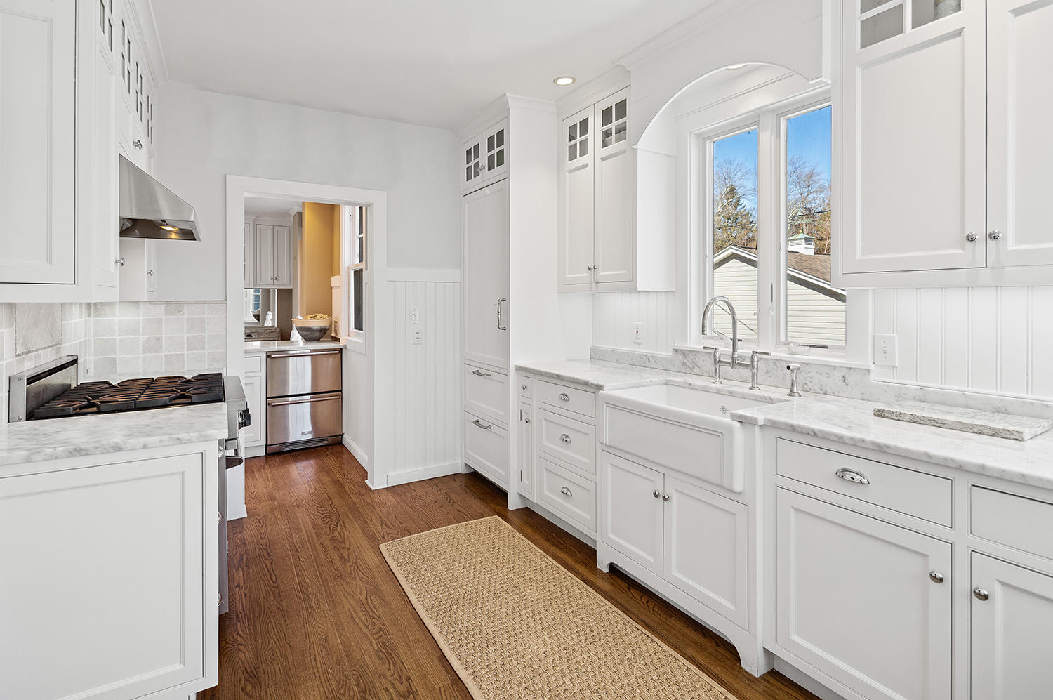 33 Old Farm Road Darien, CT 06820 - Photo 10 of 28 a kitchen with white cabinets and wooden floor