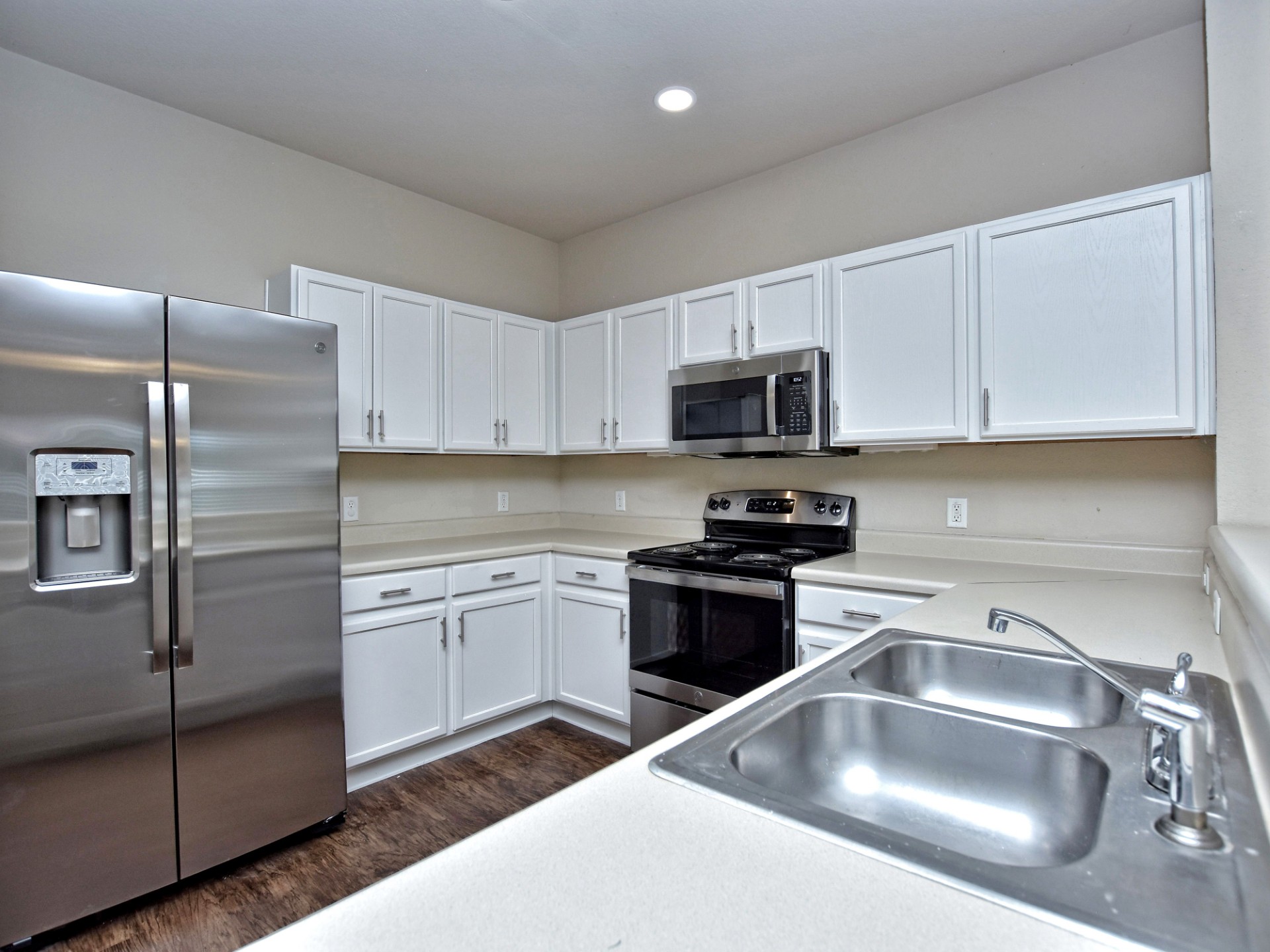 917 East 3rd Street Georgetown, TX 78626 - Photo 5 of 23 Stainless steel appliances and ample counter space create a functional cooking environment.