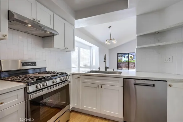 a kitchen with granite countertop a stove and a sink