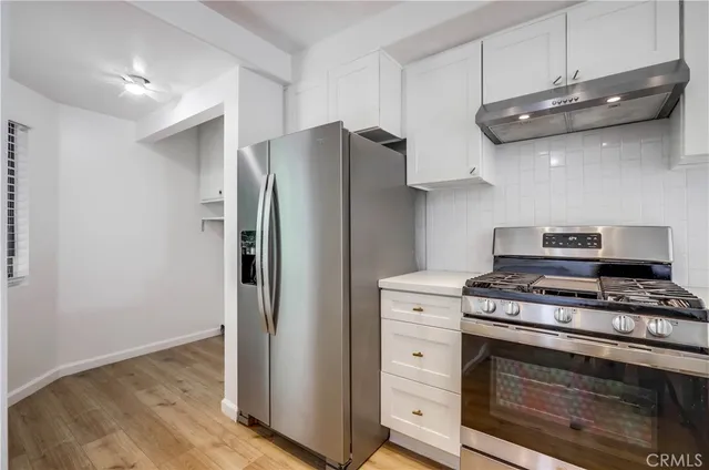 a kitchen with stainless steel appliances a stove and a refrigerator