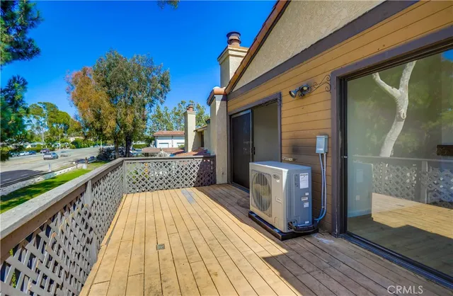 a view of balcony with wooden floor and outdoor seating
