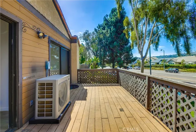 a view of balcony with wooden floor and fence