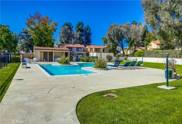 an aerial view of a house with a yard and potted plants