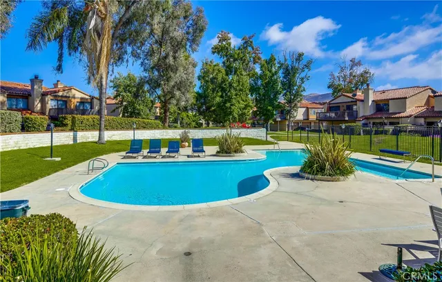 a view of a house with a yard and sitting area