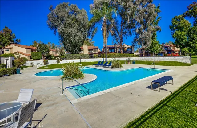 a view of a swimming pool and lounge chairs