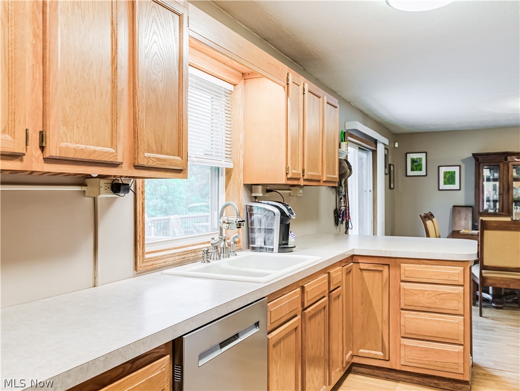 2700 Old Forge Road Kent, OH 44240 - Photo 12 of 34 Kitchen with sink, dishwasher, kitchen peninsula, and light hardwood / wood-style flooring