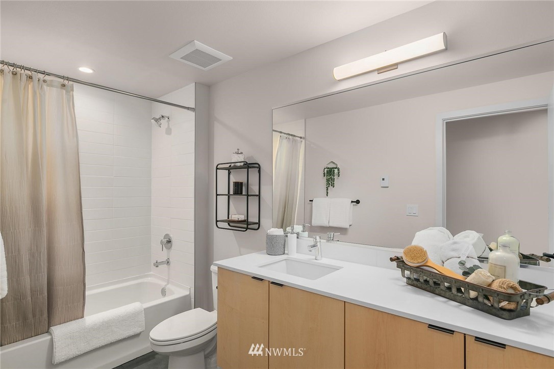 5200 Renton Avenue South Seattle, WA 98118 - Photo 20 of 21 a bathroom with a granite countertop sink a toilet and shower